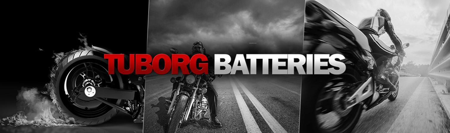 napis tuborg batteries na tle motocyklisty i drogi